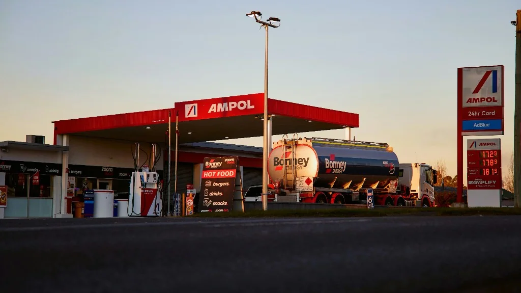 Ampol petrol station with Bonney Energy diesel tanker and diesel price board at dawn