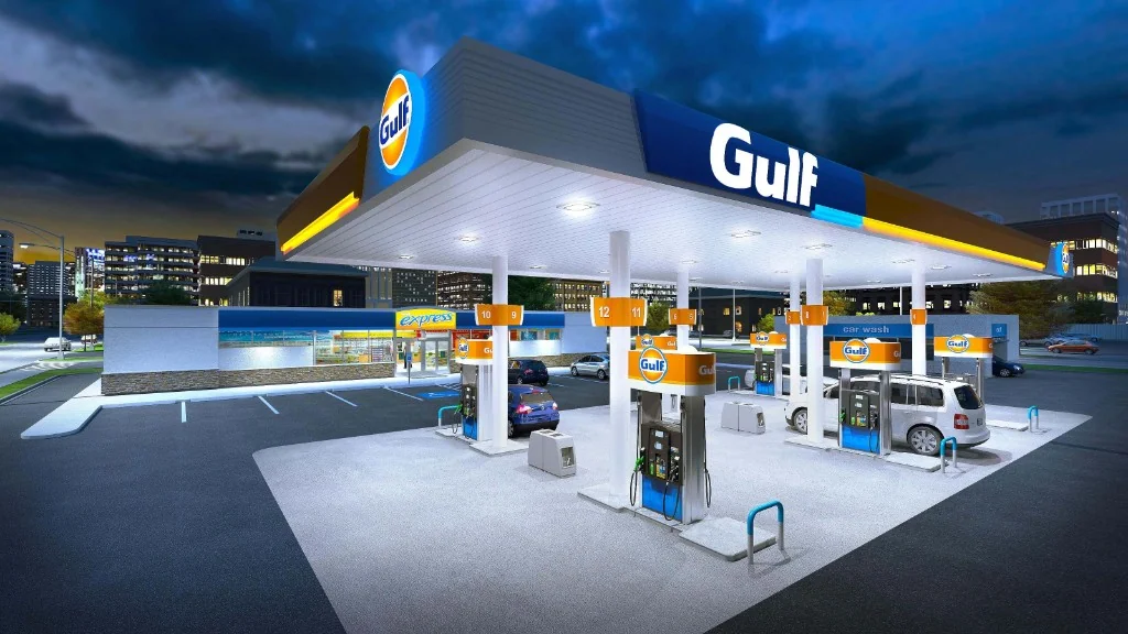 Modern Gulf petrol station with blue and orange canopy, fuel pumps, and express convenience store