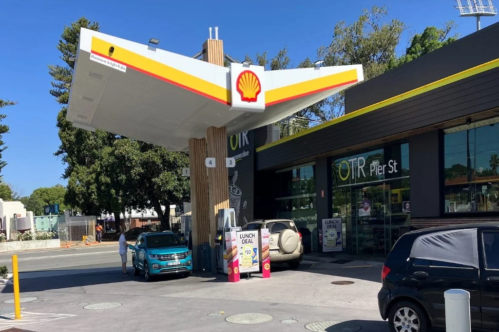 Shell petrol station forecourt with OTR convenience store and yellow and red Shell canopy