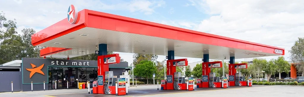 Caltex petrol station with red canopy, fuel pumps, and convenience store