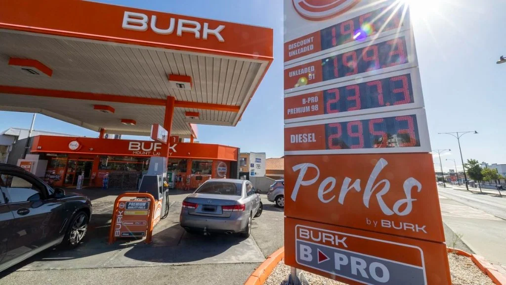 BURK petrol station with orange canopy and digital fuel price board showing unleaded and diesel