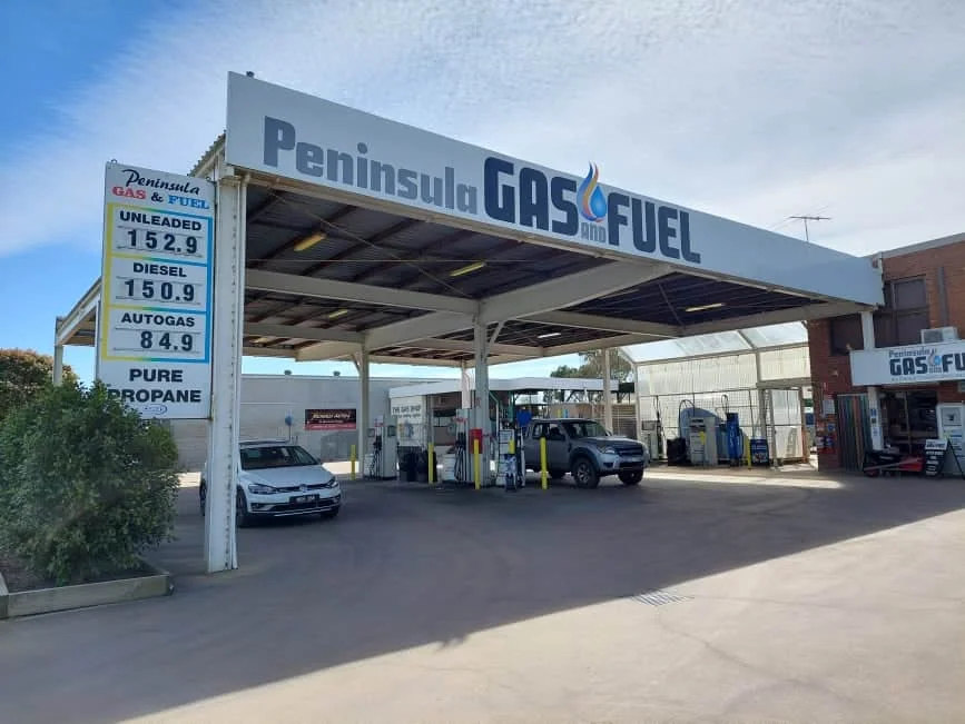 Peninsula Gas & Fuel forecourt on the Mornington Peninsula with white canopy, price board, and fuel pumps