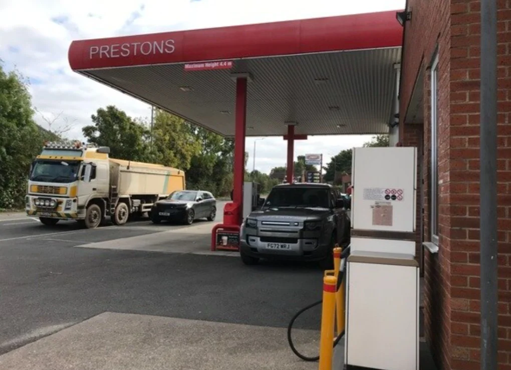 Prestons petrol station forecourt on Bell Street in Preston with vehicles at the bowsers